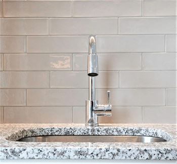 granite countertops and tile backsplash